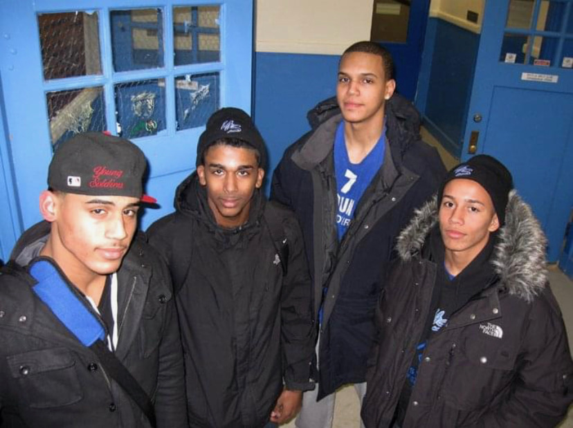 Four early Young Soldiers members in team caps at a Salem school